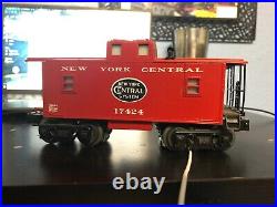 Lionel train set, New York Central 7795 with boxcar, flatcar, tipper, and caboose
